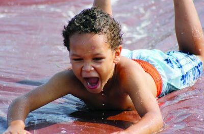 FEATURES
Antonio Galtin glides down the slip-and-slide in haste. (Date of publication: July 23, 2023) (Sophia Bales | The Richmond (Missouri) News)