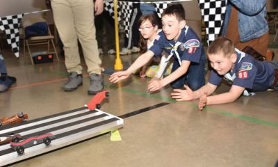 Saturday night at the track — Nearly 30 members of Centralia Boy Scout Troop 90 and Centralia Cub Scout Pack 90 packed into the gym at the Centralia First Baptist Church the evening of Saturday, Feb. 26 and raced nearly two-dozen hand-carved wooden cars down a 50-foot aluminum track for the organizations’ annual Pinewood Derby. Shown above, from the left, are Ashlee Adams, Daniel Adams and Garon Stowers eagerly watching their cars come to crashing conclusions at the finish line. (James Smith | Centralia (Missouri) Fireside Guard)