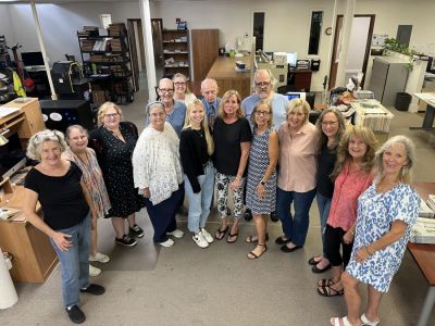 THE TEAM — From left are Beacon staff members Barb Shepherd, publisher and founder; Margie Dykes, newsroom manager; Robin Mimna, main contributing writer; Marsha McLaughlin, photographer who has been with us since the beginning, and who is deaf, by the way; Keith Allen, proofreader (yes, we still proofread!) and copy editor; Jan Giroux, in back, longest-serving ad salesperson at more than 30 years; Teagan Reamer, in front (black shirt), our graphic artist and our newest employee; Al Everson, veteran reporter who covers four government beats and much more; Karen Bures, advertising-department coordinator; Dennis Fair, in back, one of the part-timers from the community who helps with the Wednesday mailing; Vicki Duckett, in front of Dennis, former graphic artist and former circulation manager, who left to start her own neurofeedback practice but still helps us from time to time; Sammie Wiggins, advertising manager; Coni Tarby, who handles the phones, classifieds, service director and works from her home in Deltona; Melodie Robinson, legal-advertising manager (legal advertising is 17% of our revenue); and Janet Dixon, longtime advertising sales representative. “This is what we call ‘the big room,’ where ad sales and editorial mix and mingle, which is a bit unusual,”publisher Barb Shepherd said. “Among these 17 people, 11 have been with the newspaper for more than 20 years.” Missing are Editor Eli Witek and Circulation Manager Dana Shapiro.