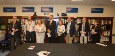 Ray Prince (fourth from left) participates in a ceremony with industry and education leaders dedicating the Raymond J. Prince Graphic Arts Collection at Cal Poly.