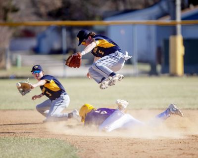 SPORTS: Sacred Heart senior Breck Bloom (5) successfully steals second base as Crookston’s George Widman flies high to avoid a collision and Crookston’s Matt Contreras reins in the ball. (May 10, 2023) [Bruce Brierley | The Exponent (East Grand Forks, Minnesota)]