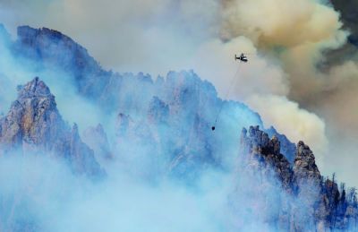 A wildfire north of Clark, Wyoming, in the Beartooth Mountain Range ignited Monday, June 14th, rapidly growing from about 40 acres in the morning to roughly 230 acres by the late afternoon. When it was first reported Sunday, the Robertson Draw Fire was burning mostly in sagebrush and grass. However, the fire moved into the timber in the Shoshone and Custer Gallatin National Forests Monday as Clark residents watched flames towering over mature trees and spreading quickly. (June 15, 2021) (Mark Davis | Powell [Wyoming] Tribune)