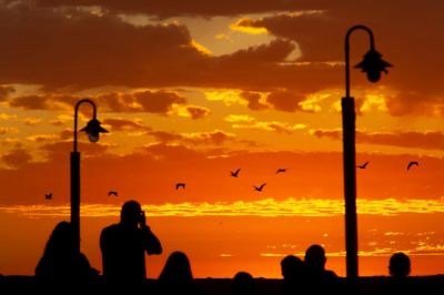 Jayson Mellom | The New Times (San Luis Obispo, California)  
People gather to photograph the sunset in Morro Bay, California. (10/10/19)