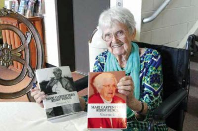 Marj Carpenter is pictured at one of her book signings at the Heritage Museum, holding up both of her Ridin’ Fence books, which are available at Heritage Museum. Marj Carpenter was an author, a well–known, respected, trusted and adored journalist and a friend to many.
