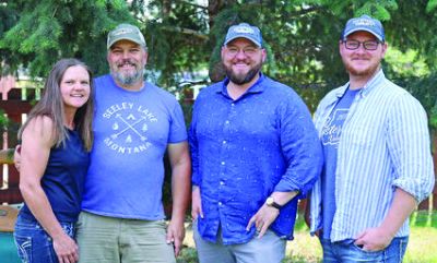 Andi and Nathan Bourne (left) with the new owners of the Seeley Swan Pathfinder, owners of Ponderosa Publications brothers Jesse Mullen (middle right) and Lloyd Mullen (right).