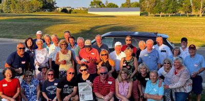 Sue Orsen (center with newspaper) showcases her last issue and attendees of her celebration party. After 44 years, Orsen is quitting publishing the Victoria (Minnesota) Gazette. (Sue Orsen)