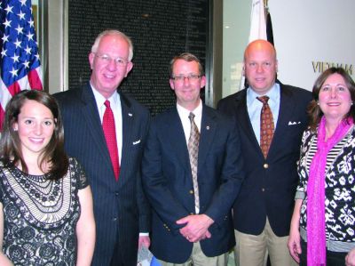 From the archives — Publishers’ Auxiliary May 2014 
NNA members meet with some of the staff of the Vietnam Veterans Memorial Fund to discuss the association’s endorsement of the fund’s Faces Never Forgotten project. From left to right, Allyson Shaw, manager of communications and media relations; Robert M. Williams Jr., NNA president; Andrew Johnson, Region 6 director; Lee A. Allen, vice president for communications, marketing and advancement; Laura Johnson with the Dodge County Pionier in Mayville, Wisconsin. Behind the group is  one of the panels from the Wall. (Stanley Schwartz | Publishers’ Auxiliary)